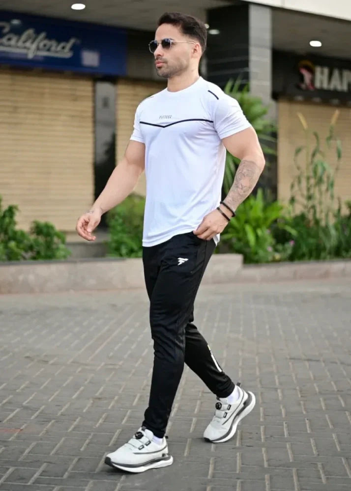 Male model wearing a two-tone white and black track suit with a bold modern design - Royal Outfits