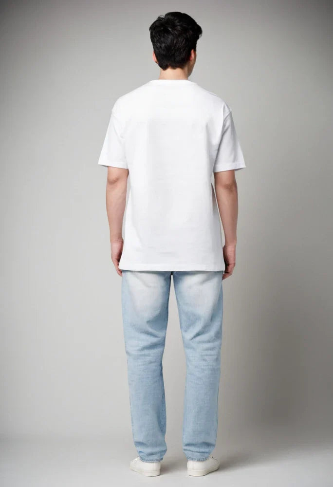 Person wearing a plain white t-shirt and light blue jeans against a gray background