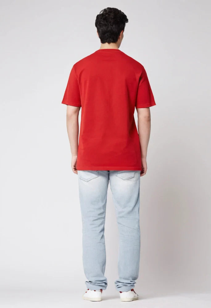 Person wearing a red polo shirt and light blue jeans on a white background