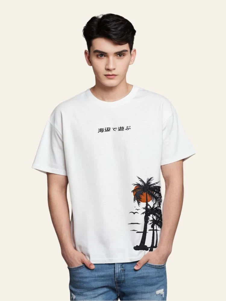 Person wearing a white t-shirt with a palm tree design on a plain background