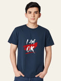 Person wearing a navy blue t-shirt with 'I AM OK' text design on a plain background Graphic Navy Blue "I'M OK" T-Shirt Royal Outfits