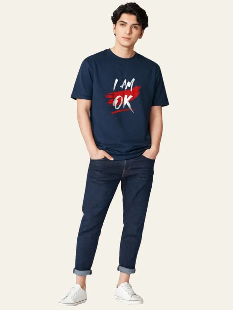 Person wearing a navy t-shirt with 'I AM OK' text on a white background