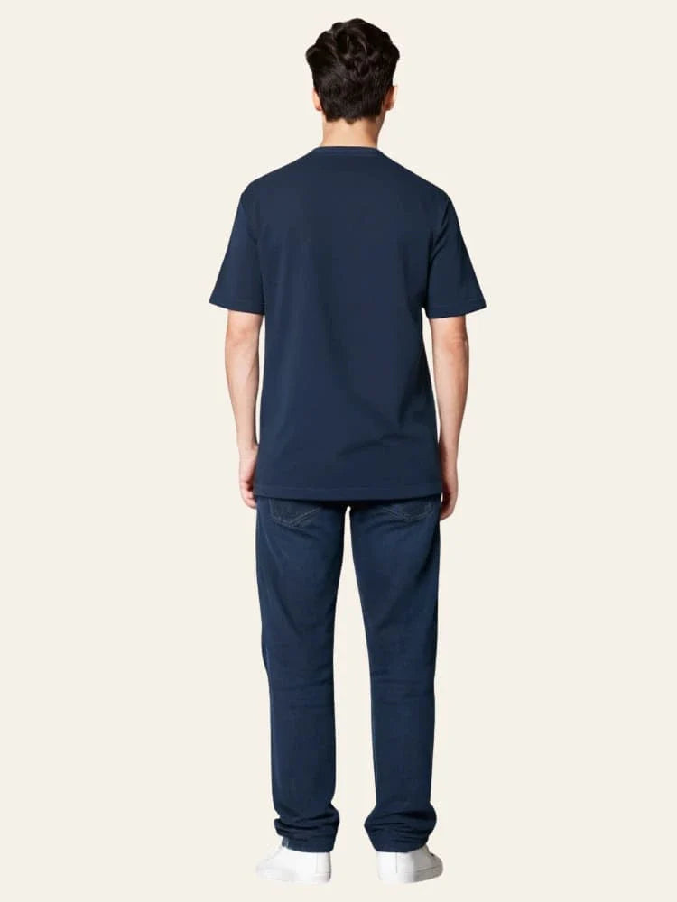 Person wearing a navy blue scrub set on a white background