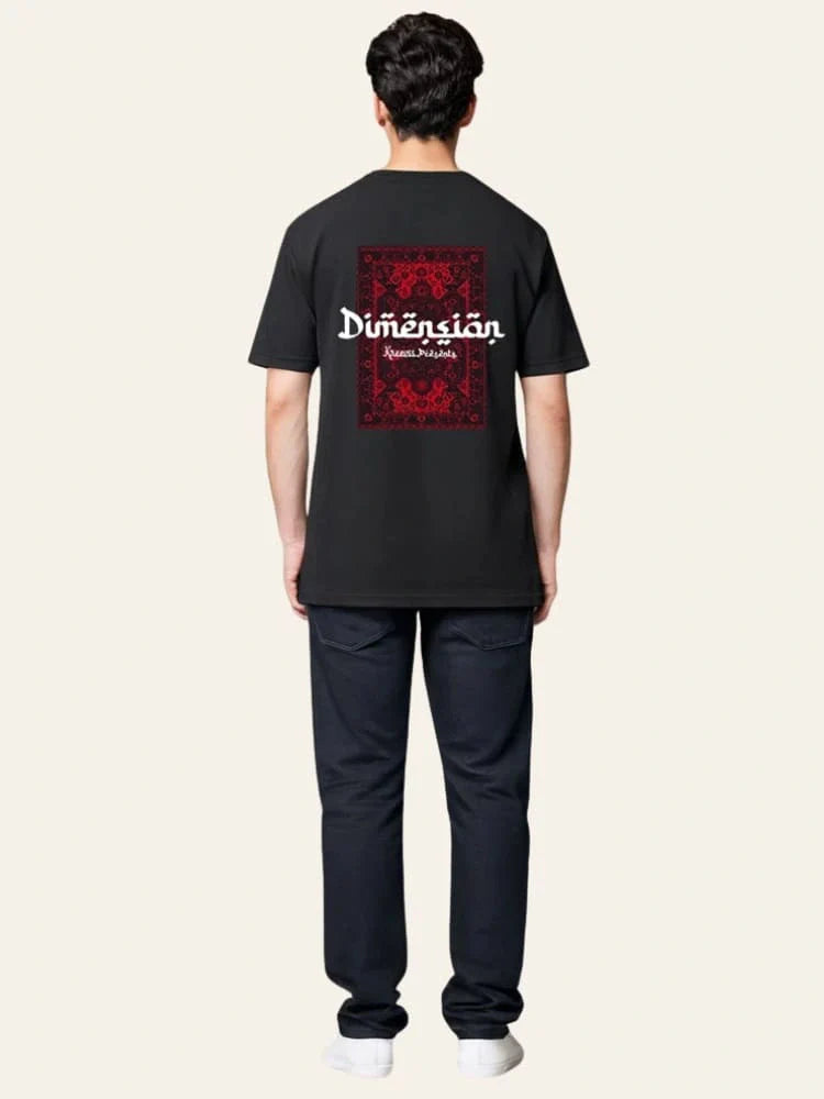 Person wearing a black t-shirt with a red and white graphic on the back against a beige background