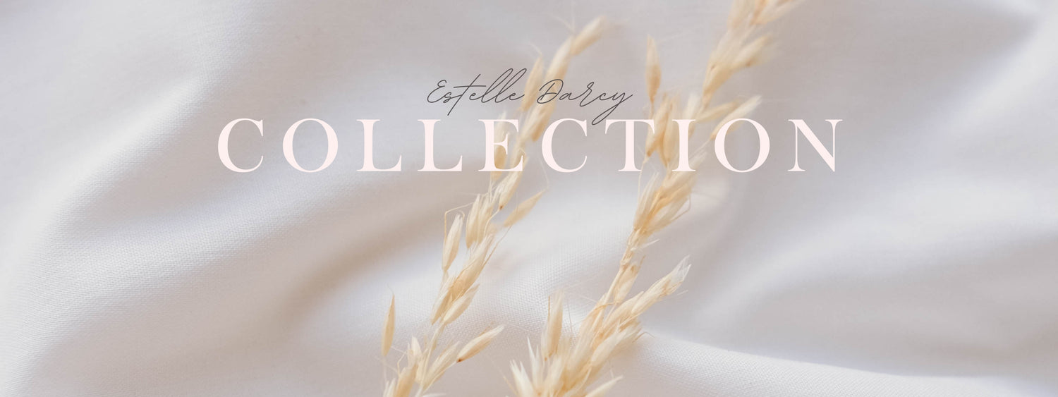 Text 'Estelle Baley Collection' on a soft beige background with a delicate plant stem.
