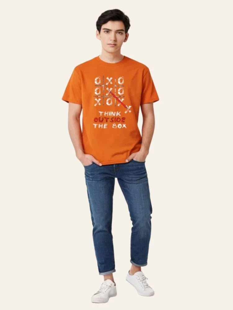 Person wearing an orange t-shirt with text and blue jeans on a white background